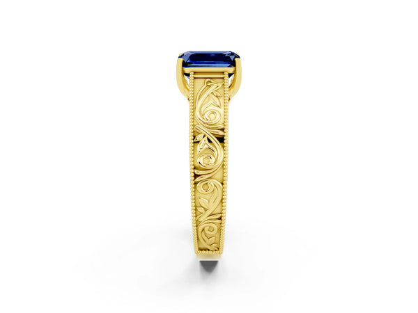 Yellow gold Emerald Cut Blue Sapphire Solitaire Ring with Engraved Band and Four-Prong Setting