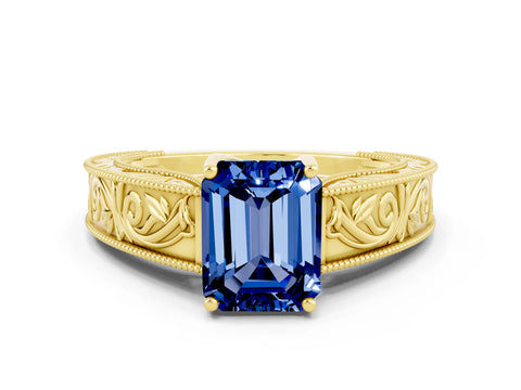 Yellow gold Emerald Cut Blue Sapphire Solitaire Ring with Engraved Band and Four-Prong Setting