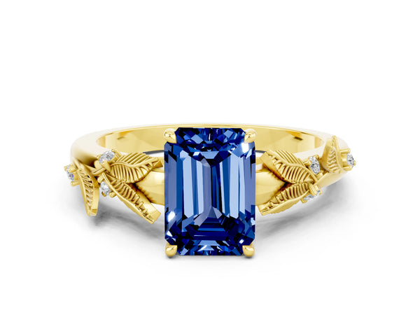 Yellow gold Emerald Cut Blue Sapphire Solitaire Ring with Leaf Motif Band and Four-Prong Setting
