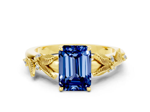 Yellow gold Emerald Cut Blue Sapphire Solitaire Ring with Leaf Motif Band and Four-Prong Setting