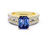 Yellow gold Emerald Cut Blue Sapphire Solitaire Ring with Pavé and Channel Set Band