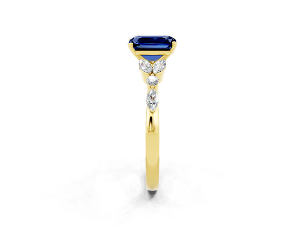 Yellow gold Emerald Cut Blue Sapphire Solitaire Ring with Side Stones and Four-Prong Setting