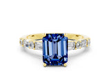Yellow gold Emerald Cut Blue Sapphire Solitaire with Side Baguettes and Channel Set Band