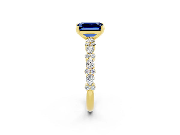 Yellow gold Emerald Cut Blue Sapphire Side Stone Solitaire Ring with Round  and Four-Prong Setting