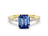 Yellow gold Emerald Cut Blue Sapphire Solitaire with Side Stones on a Pavé Band and Four-Prong Setting