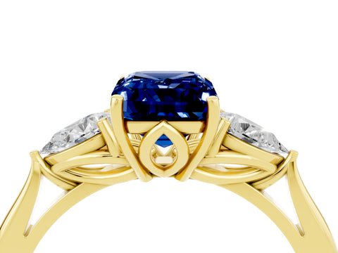 Yellow gold Emerald Cut Blue Sapphire Three-Stone Ring with Pear Side Stones and Four-Prong Setting_16