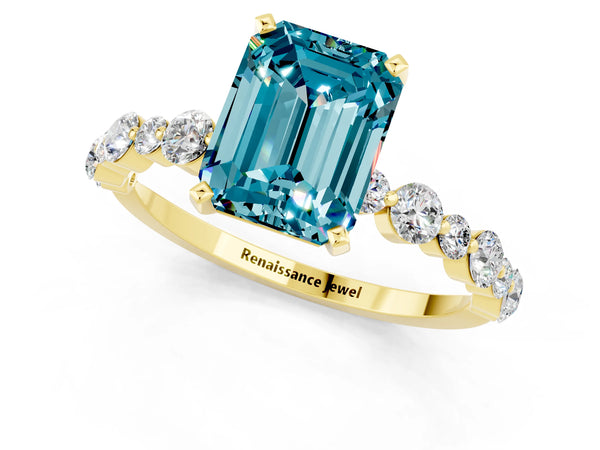Yellow gold Emerald Cut Blue Topaz Prong Set Engagement Ring with Pavé Band