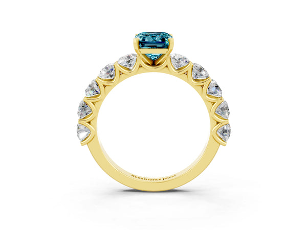 Yellow gold Emerald Cut Blue Topaz Prong Setting with Side Stones on a Pave Band