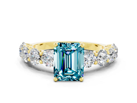 Yellow gold Emerald Cut Blue Topaz Prong Setting with Side Stones on a Pave Band
