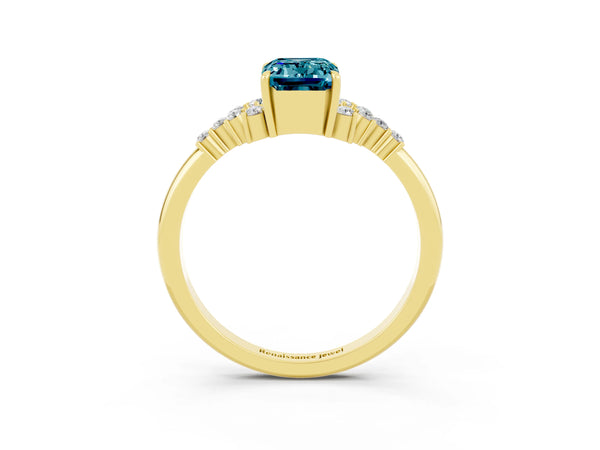 Yellow gold Emerald Cut Blue Topaz Ring with Side Stones and Four-Prong Setting