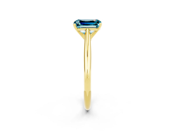 Yellow gold Emerald Cut Blue Topaz Solitaire Engagement Ring with Cathedral Setting and Four-Prong Mount