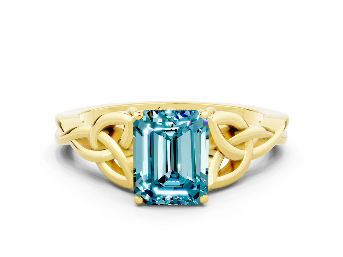 Yellow gold Emerald Cut Blue Topaz Solitaire Engagement Ring with Celtic Knot Band and Four-Prong Setting