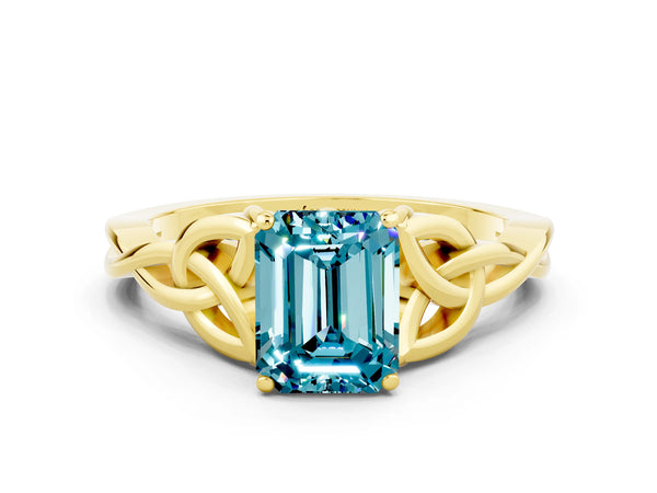 Yellow gold Emerald Cut Blue Topaz Solitaire Engagement Ring with Celtic Knot Band and Four-Prong Setting