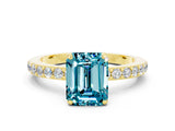 Yellow gold Emerald Cut Blue Topaz Solitaire Engagement Ring with Pavé Band and Four-Prong Setting