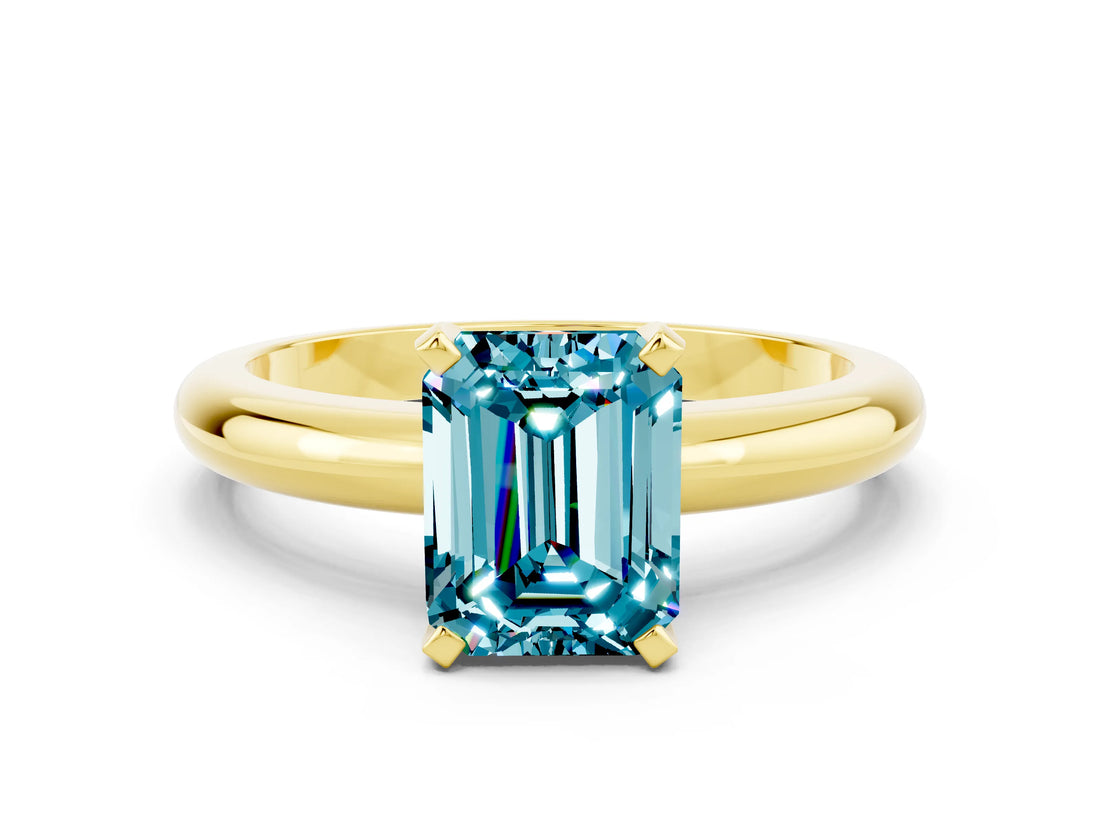 Yellow gold Emerald Cut Blue Topaz Solitaire Engagement Ring with Round Band and Four-Prong Setting