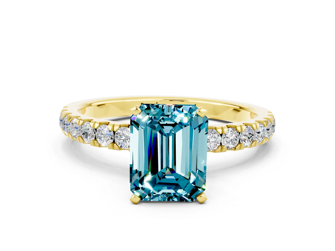 Yellow gold Emerald Cut Blue Topaz Solitaire Ring with Pavé Accents and Four-Prong Setting
