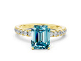 Yellow gold Emerald Cut Blue Topaz Solitaire Ring with Pavé Accents and Four-Prong Setting