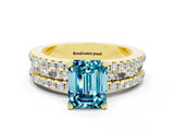Yellow gold Emerald Cut Blue Topaz Solitaire Ring with Pavé and Channel Set Band