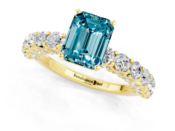 Yellow gold Emerald Cut Blue Topaz Solitaire Ring with Shared Prong Pavé Band and Four-Prong Setting