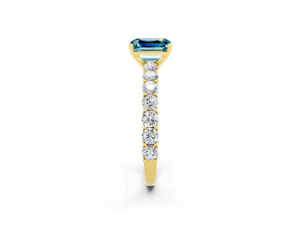 Yellow gold Emerald Cut Blue Topaz Solitaire Ring with Shared Prong Pavé Band and Four-Prong Setting