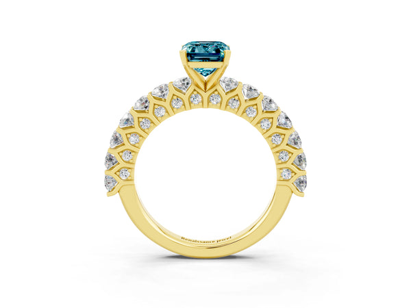 Yellow gold Emerald Cut Blue Topaz Solitaire Ring with Shared Prong Pavé Band and Four-Prong Setting