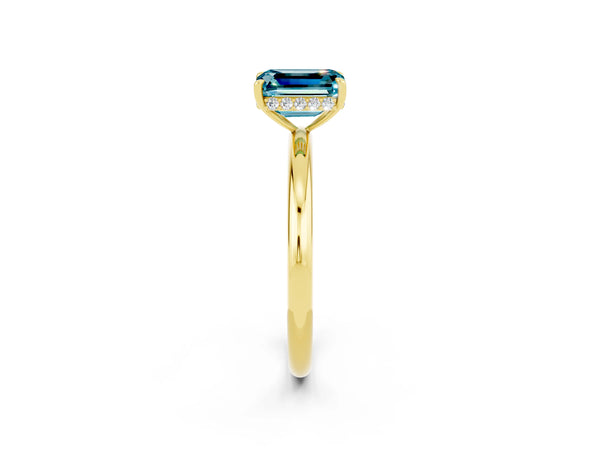 Yellow gold Emerald Cut Blue Topaz Solitaire Ring with Thin Band and Four-Prong Setting
