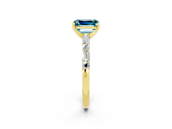 Yellow gold Emerald Cut Blue Topaz Solitaire with Side Baguettes and Channel Set Band