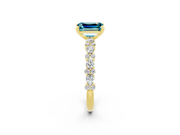 Yellow gold Emerald Cut Blue Topaz Side Stone Solitaire Ring with Round  and Four-Prong Setting