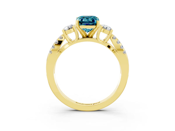 Yellow gold Emerald Cut Blue Topaz Three-Stone Ring with Pavé Split Shank and Four-Prong Setting
