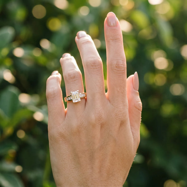 Yellow gold Emerald Cut Channel Set Solitaire Ring with Four-Prong Setting