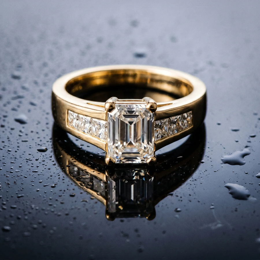 Yellow gold Emerald Cut Channel Set Solitaire Ring with Four-Prong Setting