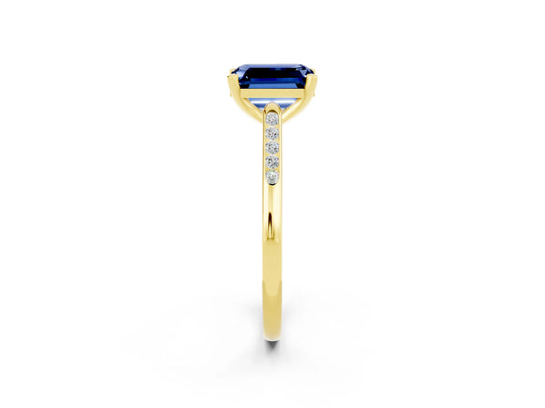 Yellow gold Emerald Cut Blue Sapphire Solitaire Ring with Channel Set Round  Band and Prong Setting