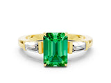 Yellow gold Emerald Cut Cut Diamond Ring with Tapered Baguette Side Stones in Four-Prong Setting