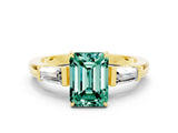 Yellow gold Emerald Cut Cut Diamond Ring with Tapered Baguette Side Stones in Four-Prong Setting