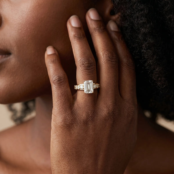 Yellow gold Emerald Cut Diamond Engagement Ring with Pavé Band and Four-Prong Setting