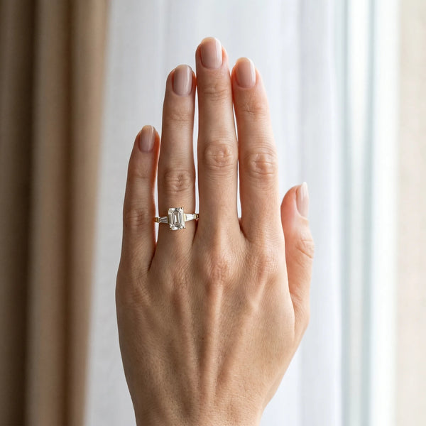 Yellow gold Emerald Cut Diamond Ring with Baguette Side Stones, Channel Set Band, and Four-Prong Setting