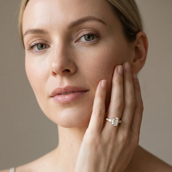 Yellow gold Emerald Cut Diamond Ring with Baguette Side Stones, Channel Set Band, and Four-Prong Setting