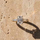 Yellow gold Emerald Cut Diamond Ring with Baguette Side Stones, Channel Set Band, and Four-Prong Setting_16
