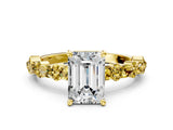 Yellow gold Emerald Cut Diamond Side Stone Solitaire Ring with Round with Yellow Sapphire side stone and Four-Prong Setting