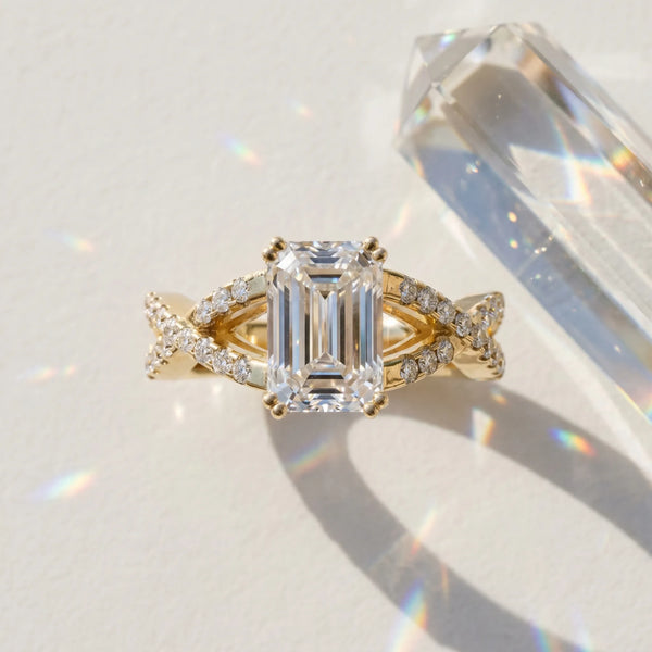 Yellow gold Emerald Cut Diamond Solitaire Ring with Four-Prong Setting and Twisted Pavé Band
