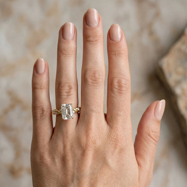 Yellow gold Emerald Cut Diamond Solitaire Ring with Twisted Band and Pavé Accents