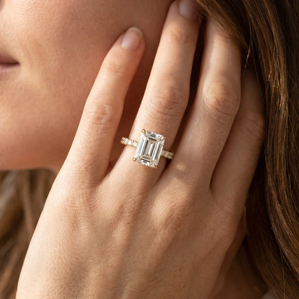 Yellow gold Emerald Cut Diamond Solitaire Ring with U-Prong Diamond Band and Four Prong Setting