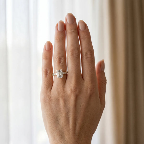 Yellow gold Emerald Cut Diamond Solitaire with Side Baguettes and Channel Set Band