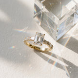 Yellow gold Emerald Cut Diamond Solitaire with Side Baguettes and Channel Set Band_111