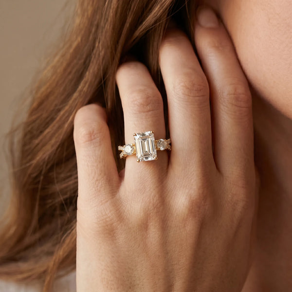 Yellow gold Emerald Cut Diamond Three-Stone Ring with Pavé Split Shank and Four-Prong Setting