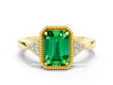 Yellow gold Emerald Cut Emerald Halo Ring with Tapered Band and Four-Prong Setting