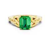 Yellow gold Emerald Cut Emerald Solitaire Engagement Ring with Celtic Knot Band and Four-Prong Setting