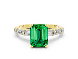 Yellow gold Emerald Cut Emerald Solitaire with Side Baguettes and Channel Set Band