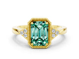 Yellow gold Emerald Cut Green Sapphire Halo Ring with Tapered Band and Four-Prong Setting