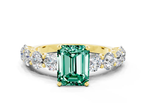 Yellow gold Emerald Cut Green Sapphire Prong Setting with Side Stones on a Pave Band